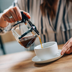 Pouring coffee from kettle