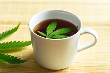 Cannabis herbal tea and marijuana leaves