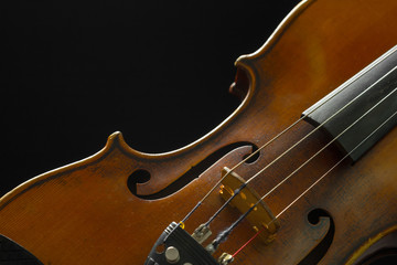 Old violin on a black background