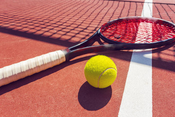 Tennis balls and racket on the grass court