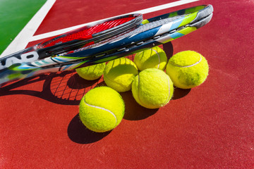 Tennis balls and racket on the grass court