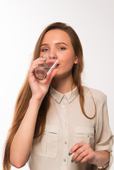 Young girl drinks clean water from a glass