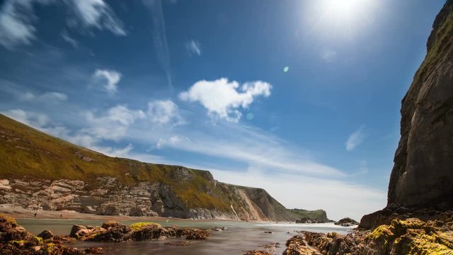 Seaside beach, rocky coastline, summer sky, timelapse