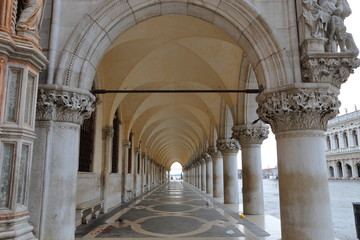 A row of arches underneath the Doge's Palace, San Marco in Venice Italy