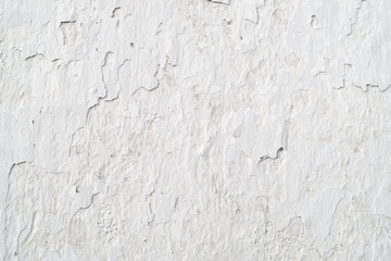 Old cracked wall covered white plaster, background, texture