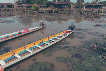 A fleet of long tail boat docking at lotus lake, Vintage tone.
