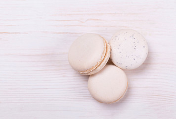 Fresh, cream-colored macaroons on a white background