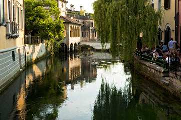 The old church of Santa Maria della Pietà is reflected on the Livenza river in Sacile. Italy