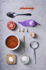 Cooking ingredients, tomato soup with spices and herbs.