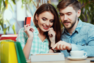 Attractive girl shopping online with man