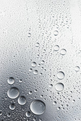 Water drops on silvery surface, background	