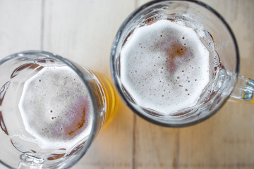 Top View Of Two Mugs Of Light Beer With Foam