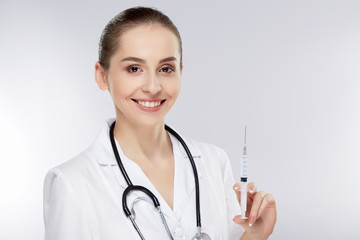 Pretty doctor in white medical uniform