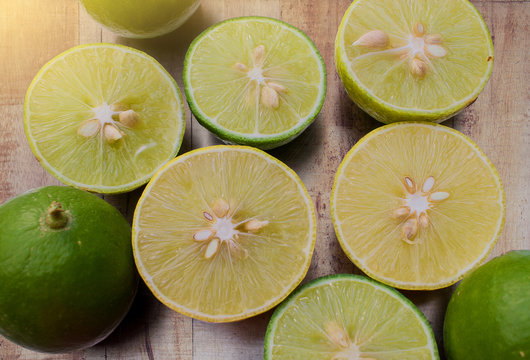 Lime with half cut laying on wooden background