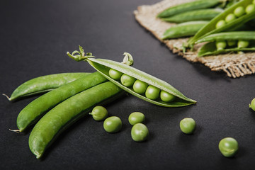 green peas on a black background closeup