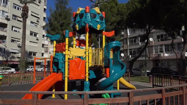 4K Kid plays and slids on space ship shaped playground