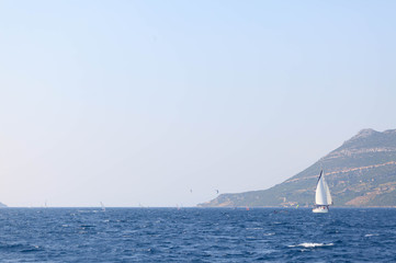Several windsurfers sail across the channel near Korcula