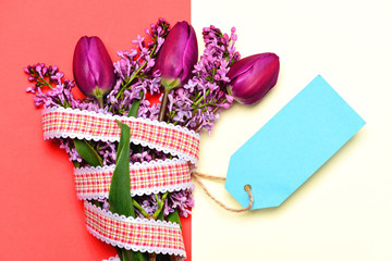 Bright bunch of flowers as gift with cyan message card