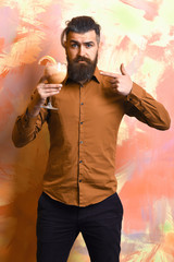 Brutal caucasian hipster holding tropical alcoholic fresh cocktail