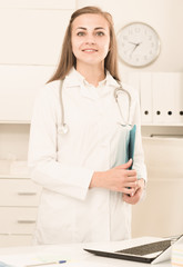 Female is standing with documents