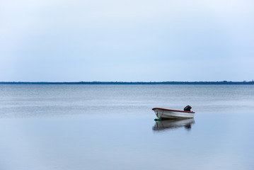 Alone small boat in calm water