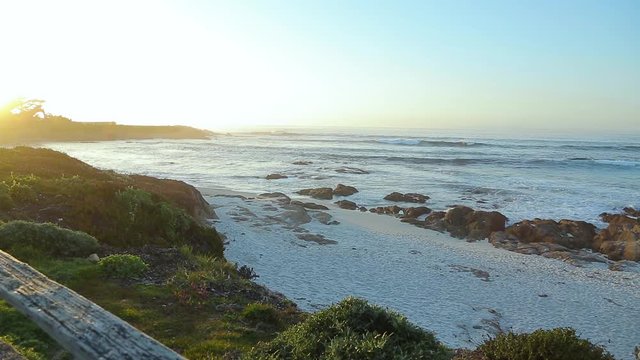Blue water and waves slow motion footage. Spanish Bay Beach in Pacific Grove, California. Coastal California Pacific ocean beach, sunset and beautiful scenery along coast. Monterey 17 Mile Drive.