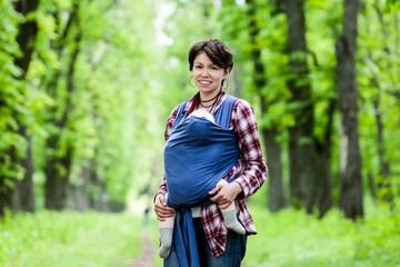 Mother with her baby in sling.