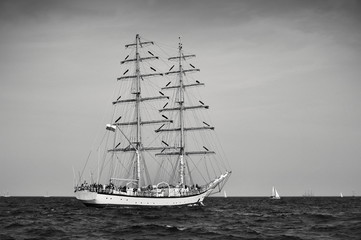 Fototapeta na wymiar Tall Ship under sail with the shore in the background