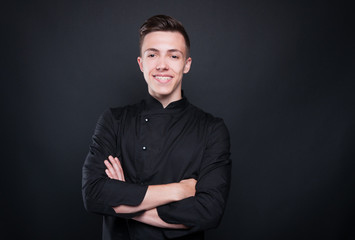 Fototapeta na wymiar Portrait of attractive male chef with crossed arms