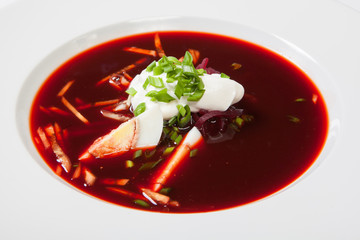 tomato soup with beetroot closeup horizontal on a white background