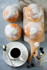 Fresh baked berliner with custard on a gray concrete background. German donats. Selective focus.Top view.