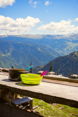 Small kettle and green plate on the veranda of the shelter