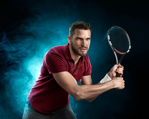 A professional tennis player with a racket in his hand concentrated and waits for the ball