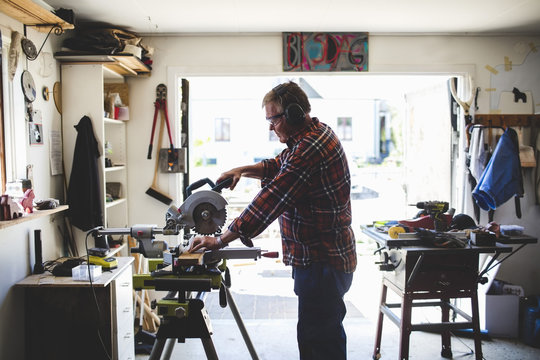 Senior man working in his garage workshop