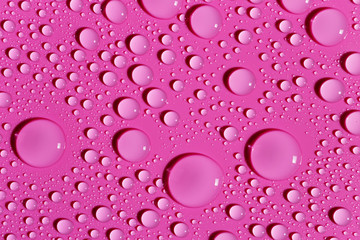 Water drops on a fuchsia surface, background
