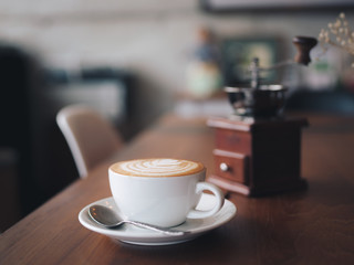 cup of coffee latte art on the wood desk coffee shop cafe