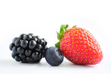 Close-up view of mixed, assorted berries blackberry, strawberry, blueberry isolated on white background.