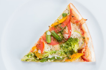 Slice of vegetarian pizza with broccoli, green beans, olives and tomatoes