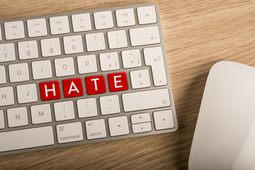 Hate key on a computer keyboard. Defamation on line concept.