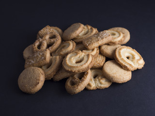 Danish butter cookies with vanilla wreaths (vanillekranse) and sugar pretzels (sukker kringler) isolated on black background