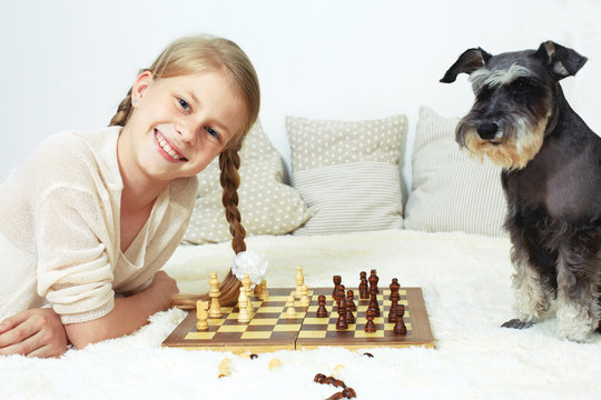 The dog teaches the child to play chess. Your move