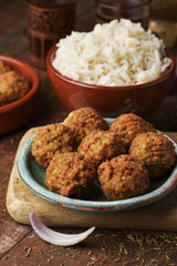falafel and long grain rice on a wooden table