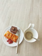 Desserts and coffee on wooden board. Picture with copy space.