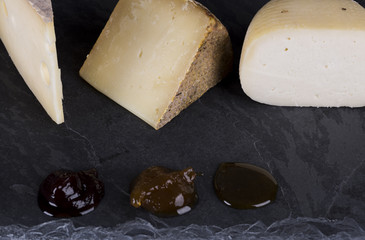 variety of cheeses served with honey and jams