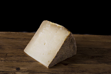 Tuscan pecorino cheese, typical Italian cheese on wooden cutting board