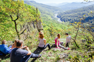People admire the views of mountain scenery, sitting on the top of the mountain and meditating