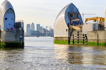 Papier Peint photo Barrage Thames Barrier in London with Canary Wharf in the background 