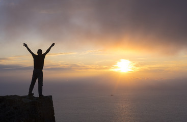 Fototapeta premium Climber on top of mountain at sunset
