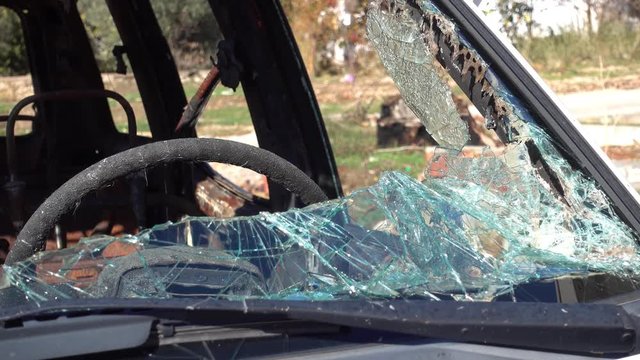 4K Shivers of windscreen glass of a blown car