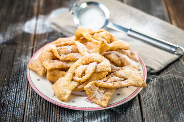 Flancat- crisp deep fried pastry dusted with powdered sugar
